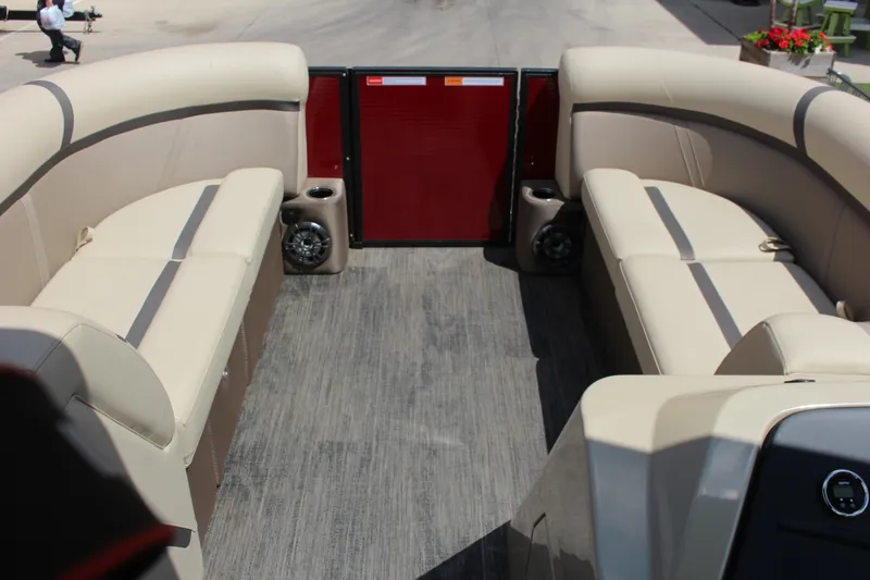 Slide: The Image of 2023 Crest 220 SLS Classic boat interior with beige seating and wood-style flooring. - 4