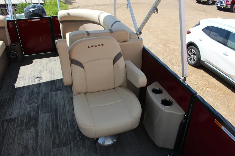 Slide: The Image of 2023 Crest 220 SLS Classic boat interior with beige seating and cup holders. - 8