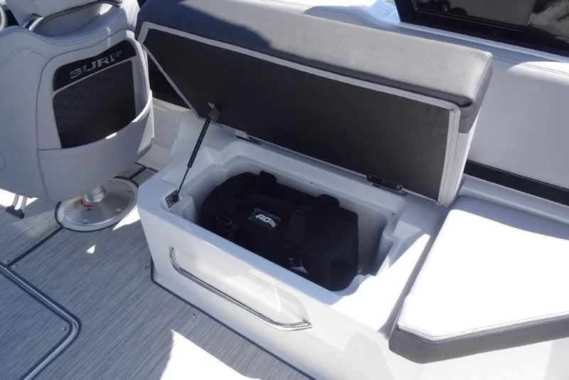 Slide: The Image of 2026 Cobalt R8 Surf boat interior with open storage compartment and seating. - 11