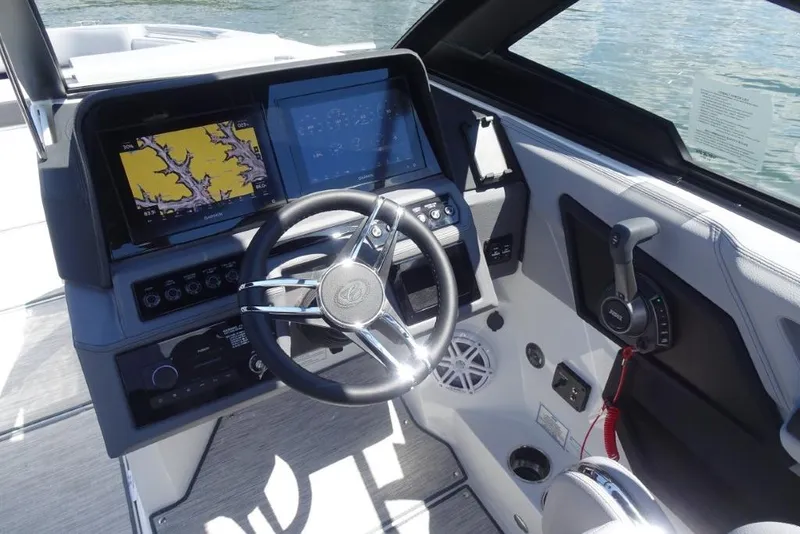 Slide: The Image of 2026 Cobalt R8 Surf boat dashboard with steering wheel and navigation screens. - 13