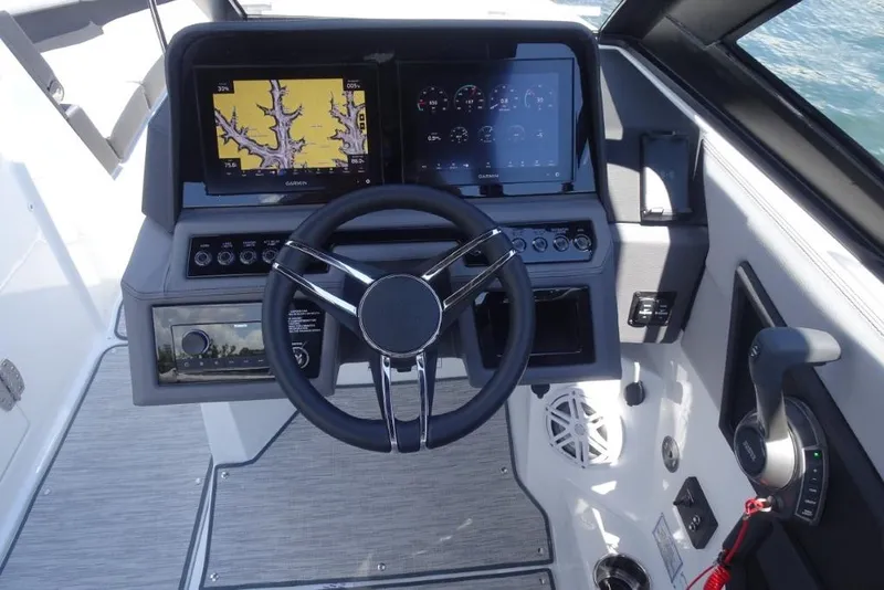 Slide: The Image of 2026 Cobalt R8 Surf boat dashboard with steering wheel and navigation screens. - 14