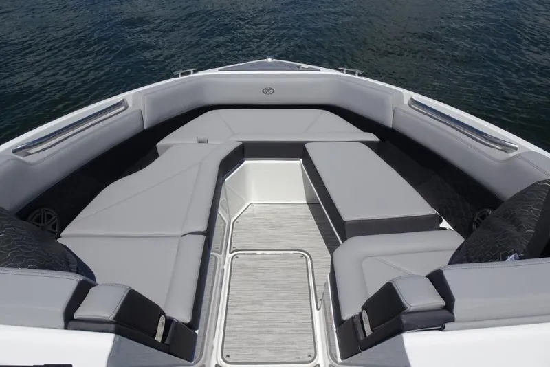 Slide: The Image of 2026 Cobalt R8 Surf boat interior with gray seating, on calm water. - 17