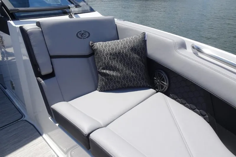 Slide: The Image of 2026 Cobalt R8 Surf boat interior with gray seating and decorative pillow. - 18