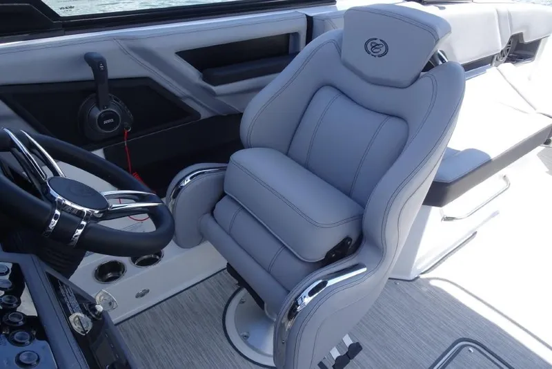 Slide: The Image of Luxurious interior of 2026 Cobalt R8 Surf boat with plush captain's chair and steering wheel. - 22