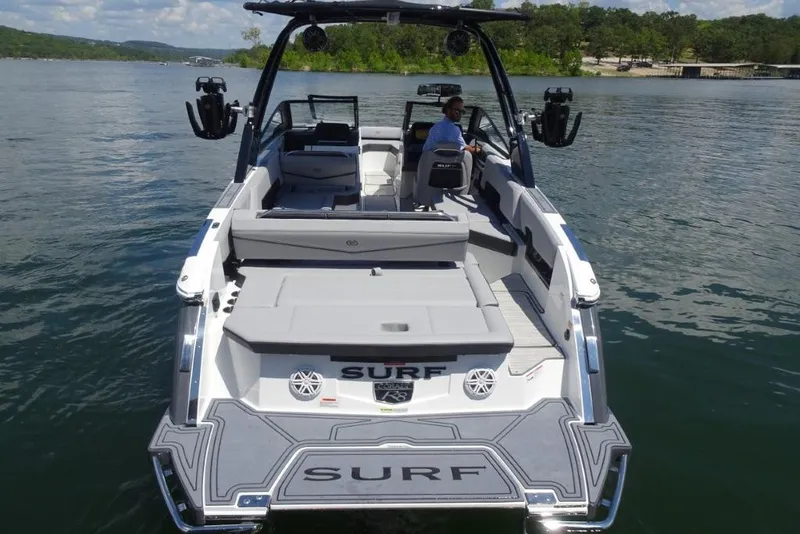 Slide: The Image of 2026 Cobalt R8 Surf boat on a lake, featuring spacious seating and modern design. - 7