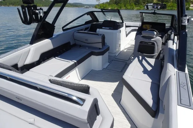 Slide: The Image of 2026 Cobalt R8 Surf boat interior with spacious seating on a sunny lake. - 9