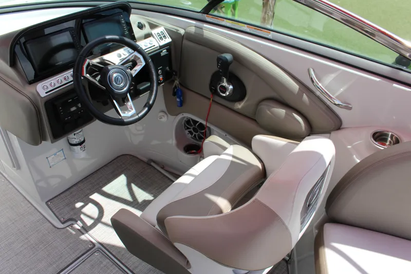 Slide: The Image of 2023 Crownline 290 SS boat cockpit with modern steering wheel and control panel. - 4