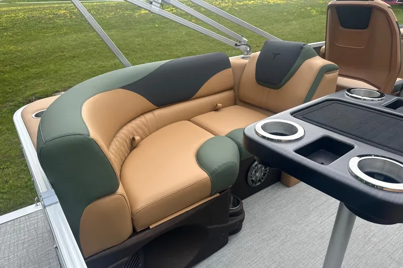 Slide: The Image of Luxurious seating on 2025 Tahoe 2185 boat, featuring tan and green upholstery with cup holders. - 10