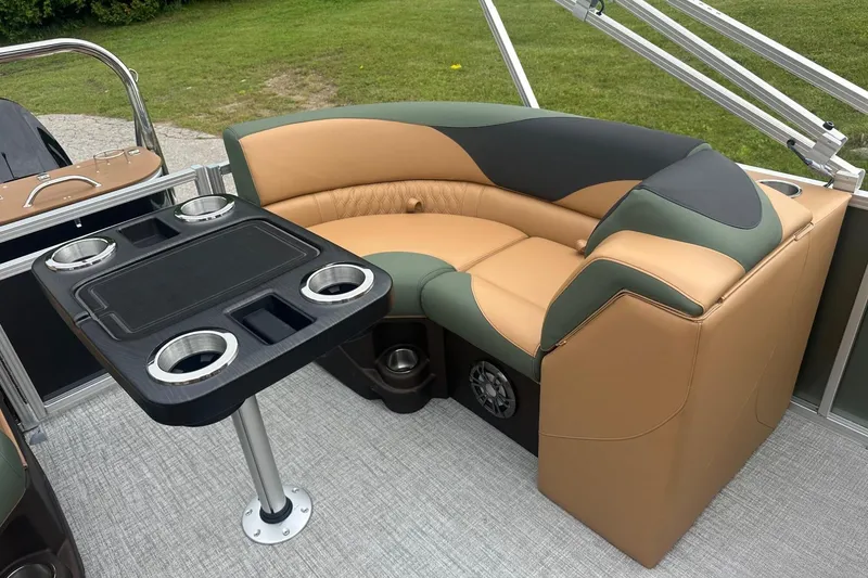 Slide: The Image of Luxurious seating area on 2025 Tahoe 2185 boat with table and cup holders. - 12