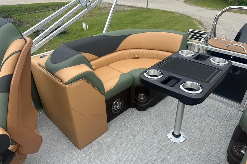 Slide: The Image of Luxurious seating and table setup on 2025 Tahoe 2185 boat, featuring cup holders. - 14