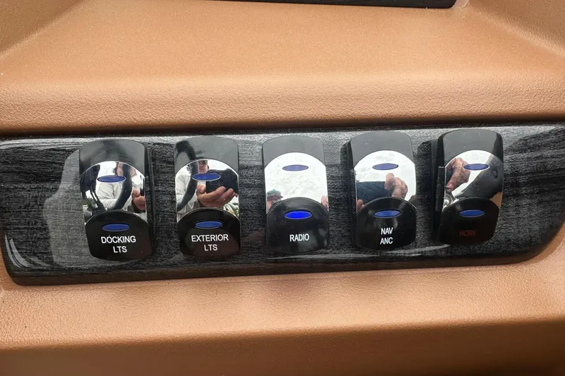 Slide: The Image of Control panel with switches for docking lights, exterior lights, radio, navigation, and horn in Tahoe 2185. - 15