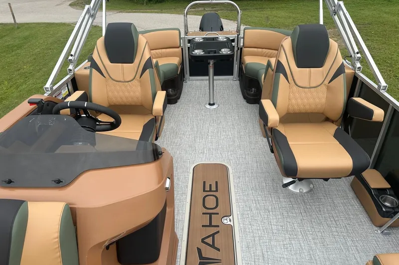 Slide: The Image of 2025 Tahoe 2185 boat interior with luxurious tan seating and modern steering console. - 24