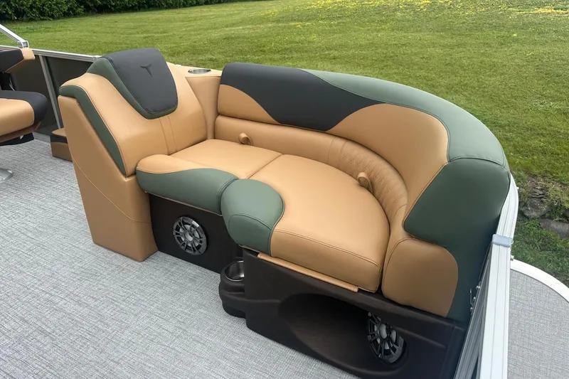 Slide: The Image of Luxurious seating on 2025 Tahoe 2185 boat, featuring tan and green upholstery with integrated speakers. - 28
