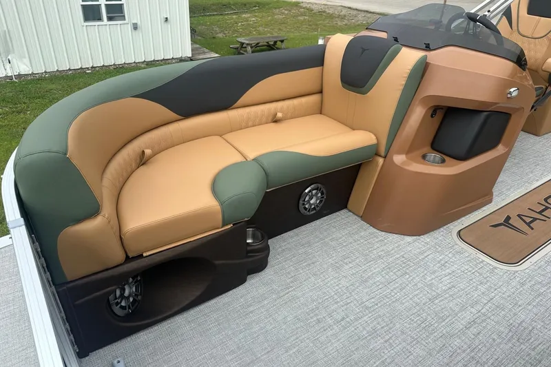 Slide: The Image of Luxurious seating on 2025 Tahoe 2185 boat, featuring tan and green upholstery with integrated speakers. - 29