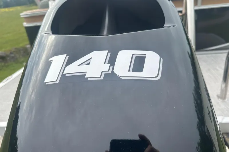 Slide: The Image of Close-up of a 2025 Tahoe 2185 boat engine with "140" decal. - 32
