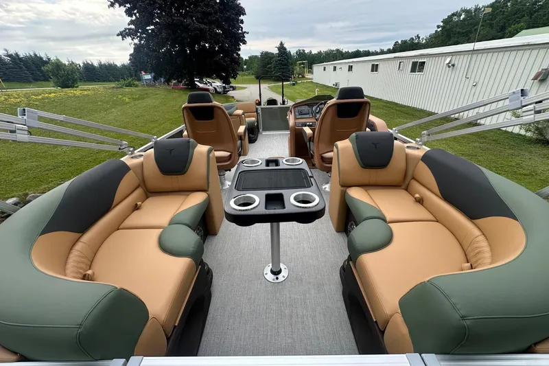 Slide: The Image of Luxurious 2025 Tahoe 2185 boat interior with plush seating and cup holders, set outdoors. - 9