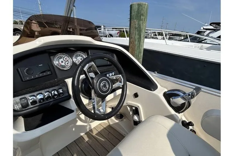 Slide: The Image of Steering console of a 2021 Avalon 2785 boat with gauges and controls. - 5