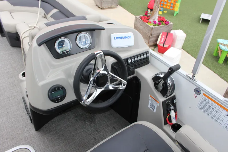 Slide: The Image of 2022 Barletta C22UC boat dashboard with steering wheel and control panel. - 4