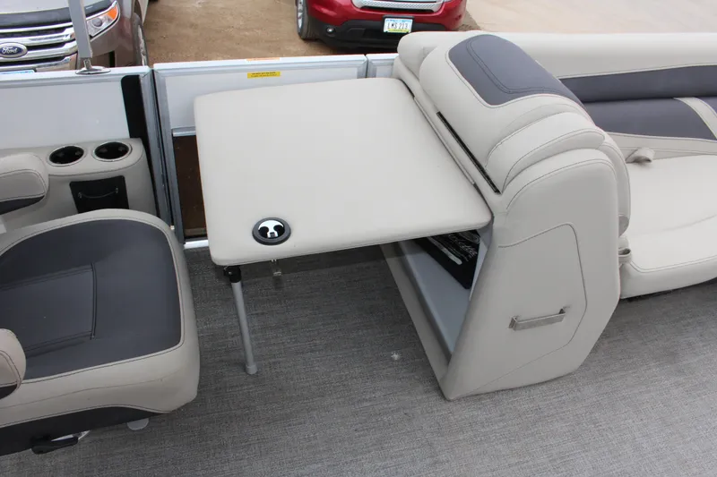 Slide: The Image of 2022 Barletta C22UC pontoon boat interior with seating and table setup. - 5
