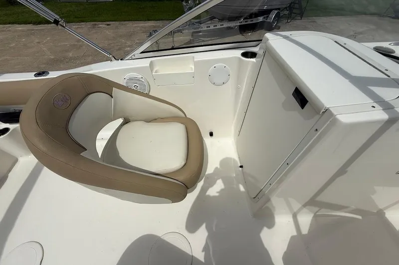 Slide: The Image of 2019 Key West 203 DFS boat interior with beige seating and storage compartment. - 13