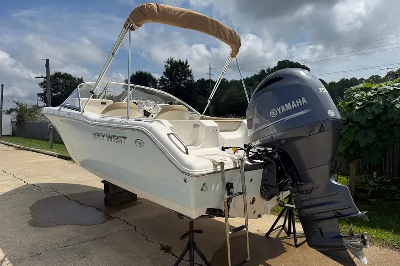Slide: The Image of 2019 Key West 203 DFS boat with Yamaha outboard motor on a driveway. - 2