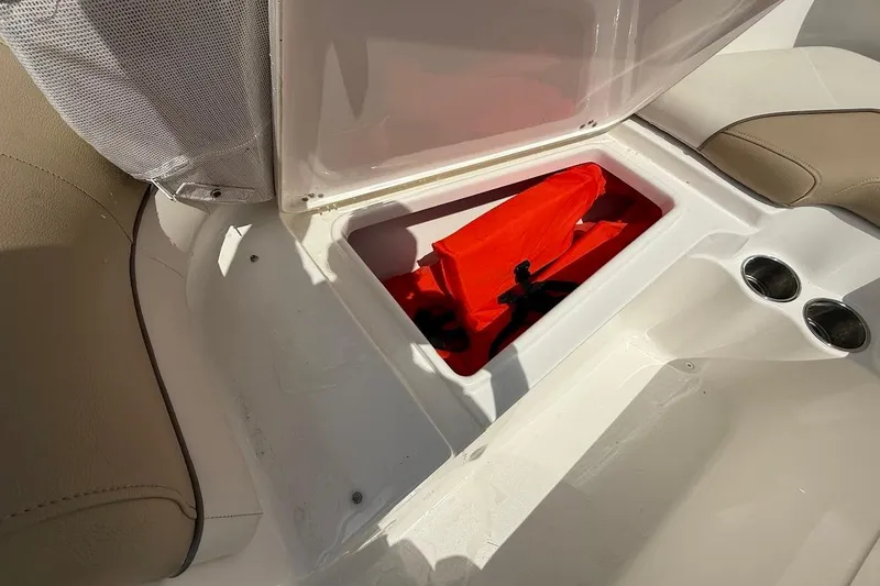 Slide: The Image of Open storage compartment in 2019 Key West 203 DFS boat with red life jacket. - 20