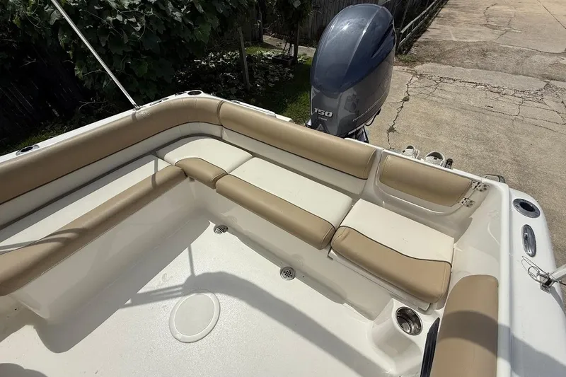 Slide: The Image of 2019 Key West 203 DFS boat with beige seating and outboard motor. - 7
