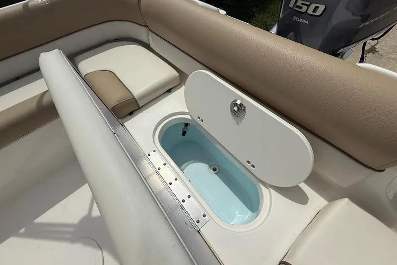 Slide: The Image of 2019 Key West 203 DFS boat interior with seating and storage compartment. - 8