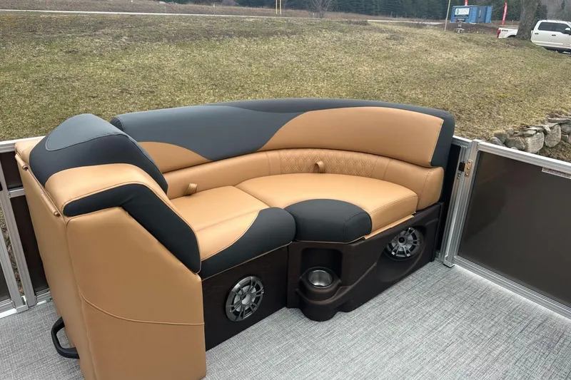 Slide: The Image of Luxurious seating on 2025 Tahoe 2185 boat, featuring tan and black upholstery with integrated speakers. - 17