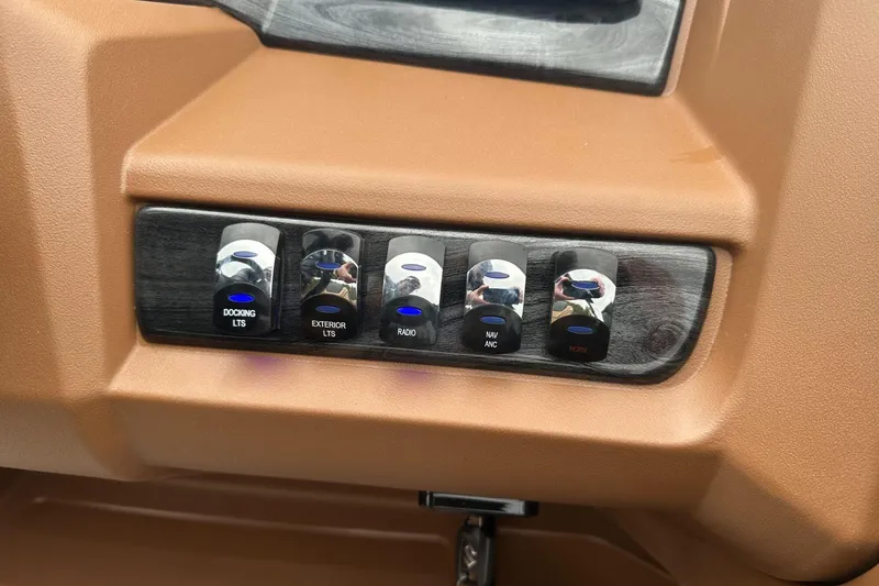 Slide: The Image of Control panel of a 2025 Tahoe 2185 with labeled switches for various functions. - 23