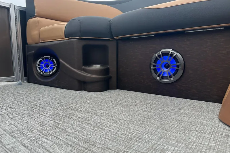 Slide: The Image of 2025 Tahoe 2185 boat interior with blue LED speakers and cushioned seating. - 24