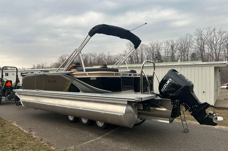 Slide: The Image of 2025 Tahoe 2185 pontoon boat with Suzuki outboard motor on trailer. - 3