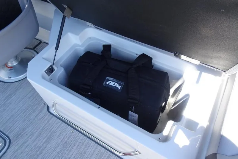 Slide: The Image of Storage compartment in 2026 Cobalt R8 Surf boat with black duffel bag inside. - 10