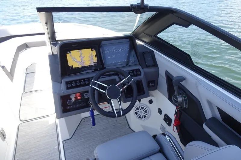 Slide: The Image of 2026 Cobalt R8 Surf boat cockpit with advanced navigation system and steering wheel. - 12