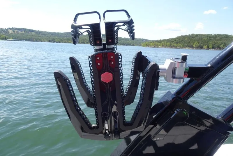 Slide: The Image of Wakeboard rack on 2026 Cobalt R8 Surf boat, lake view background. - 14