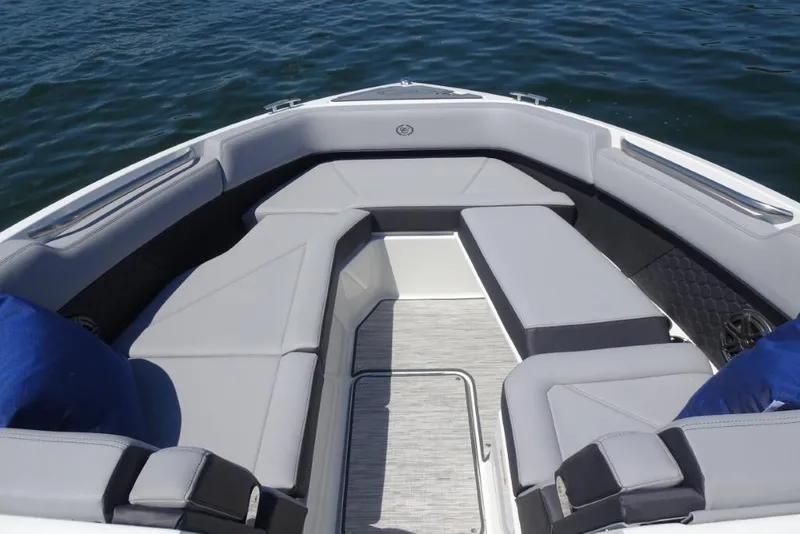 Slide: The Image of 2026 Cobalt R8 Surf boat interior with gray seating on calm water. - 18