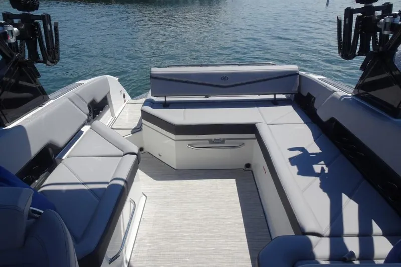 Slide: The Image of 2026 Cobalt R8 Surf boat interior with luxurious seating on calm water. - 21
