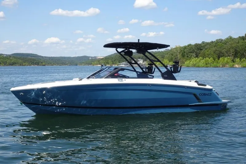 Slide: The Image of 2026 Cobalt R8 Surf boat on a scenic lake with clear skies. - 5