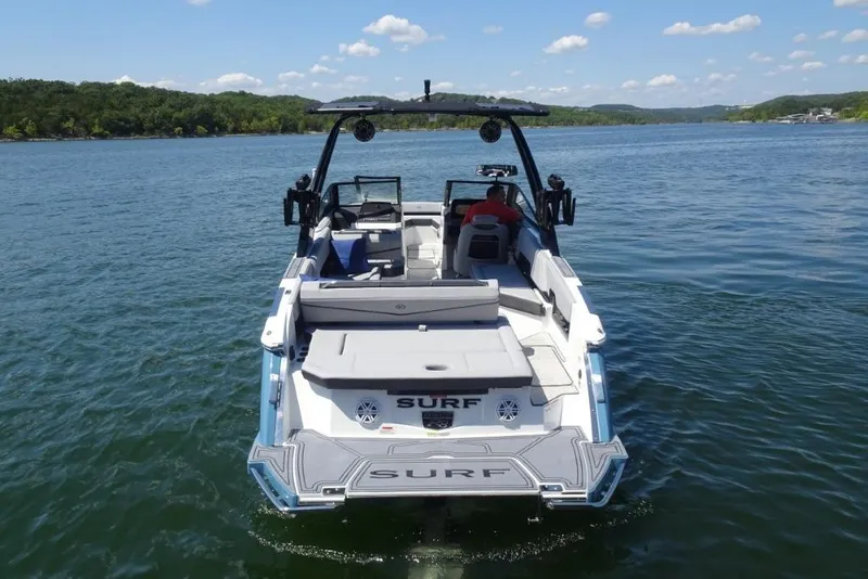 Slide: The Image of 2026 Cobalt R8 Surf boat on a serene lake with clear skies. - 6