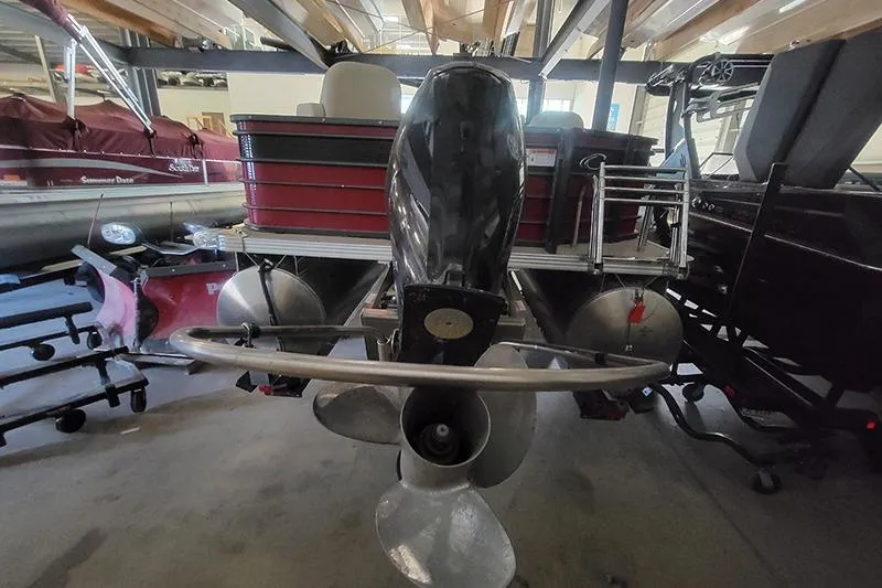 Slide: The Image of 2022 Crest 220 SF pontoon boat in storage, rear view with motor and propeller. - 3