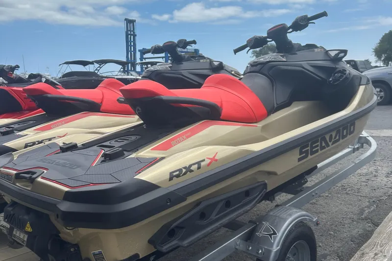 Slide: The Image of 2025 Sea-Doo RXT-X 325 jet skis on trailer, featuring sleek design and vibrant colors. - 7
