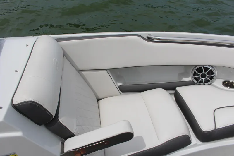 Slide: The Image of 2022 Crownline 240 SS boat interior with white cushioned seating and speaker. - 12