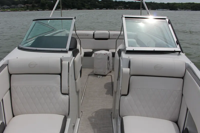 Slide: The Image of 2022 Crownline 240 SS boat interior with luxurious seating on a lake. - 13