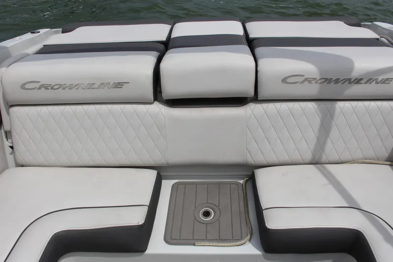 Slide: The Image of 2022 Crownline 240 SS boat interior seating with quilted upholstery and logo. - 14