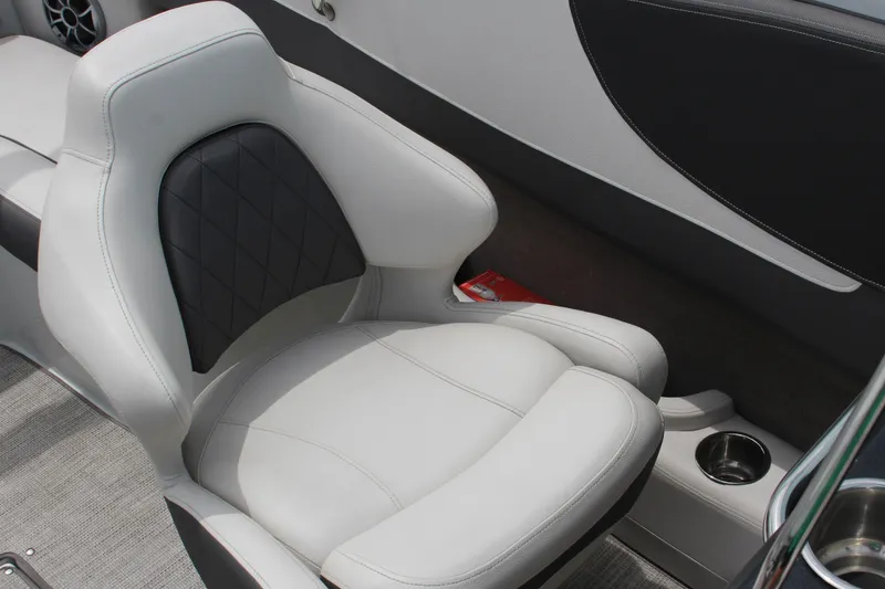 Slide: The Image of 2022 Crownline 240 SS boat interior with plush seating and cup holder. - 6