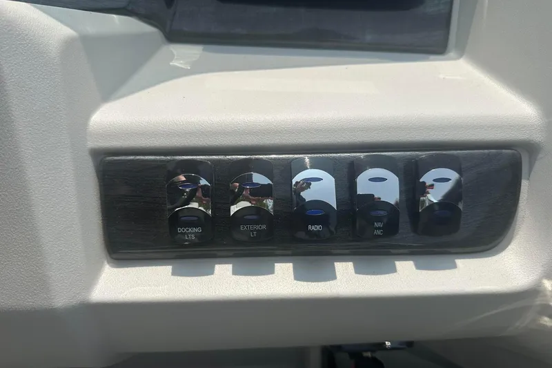 Slide: The Image of Control panel of a 2025 Tahoe 2185 boat with labeled switches. - 20