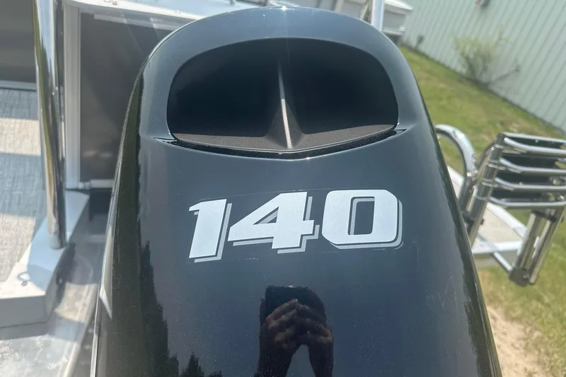 Slide: The Image of Close-up of a 2025 Tahoe 2185 outboard motor with "140" label. - 25
