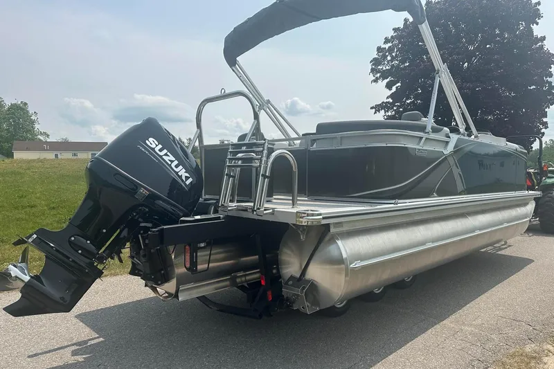 Slide: The Image of 2025 Tahoe 2185 pontoon boat with Suzuki outboard motor on a sunny day. - 7