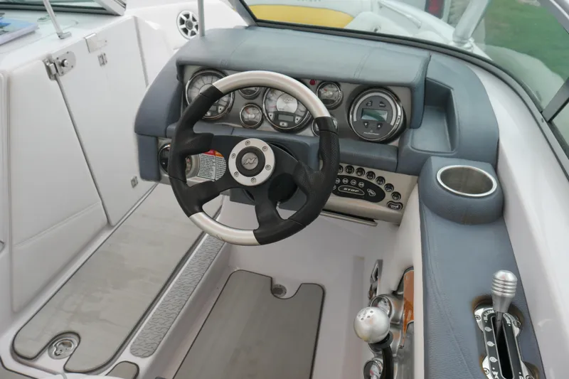 Slide: The Image of 2007 Correct Craft 236 Team Edition boat dashboard with steering wheel and controls. - 10