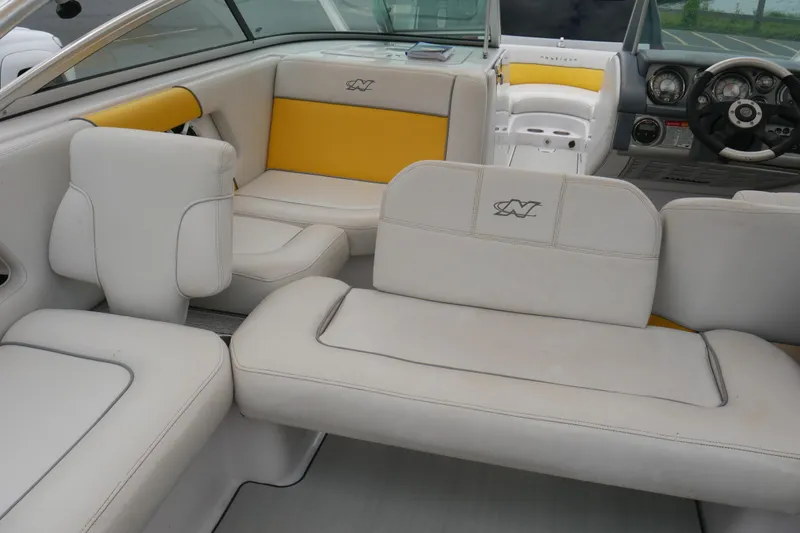 Slide: The Image of 2007 Correct Craft 236 Team Edition boat interior with white and yellow seating. - 16